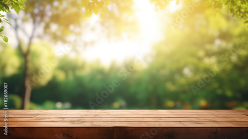 Wooden table and blurred green nature garden background © areef