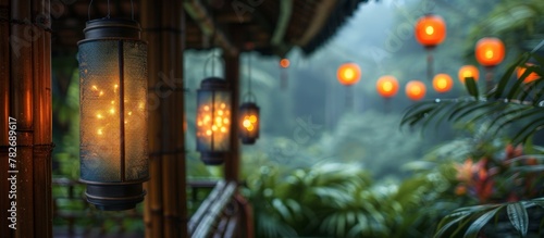 Lanterns are illuminated and hanging on a porch  casting a warm glow in the rain