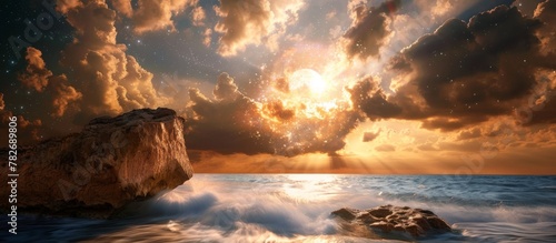 The sun setting over a rugged cliff by the ocean, creating a picturesque view of nature's beauty