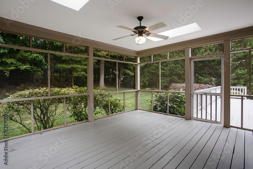 Obraz na płótnie Screened-In Porch with A Ceiling Fan, View of Lush Trees Through the Mesh, Skylights with Natural Light w salonie