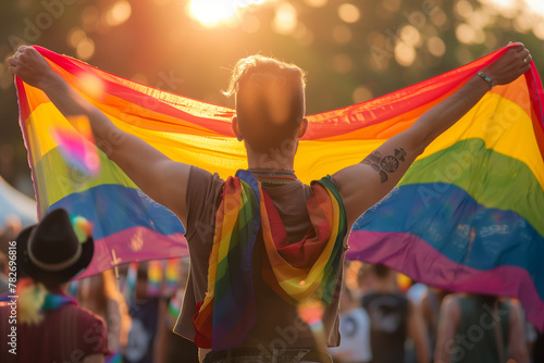 Person Holding Rainbow Flag at Sunset, LGBTQ Pride and Freedom photo