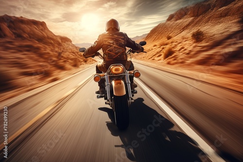 A back view of a biker speeding through a desert highway