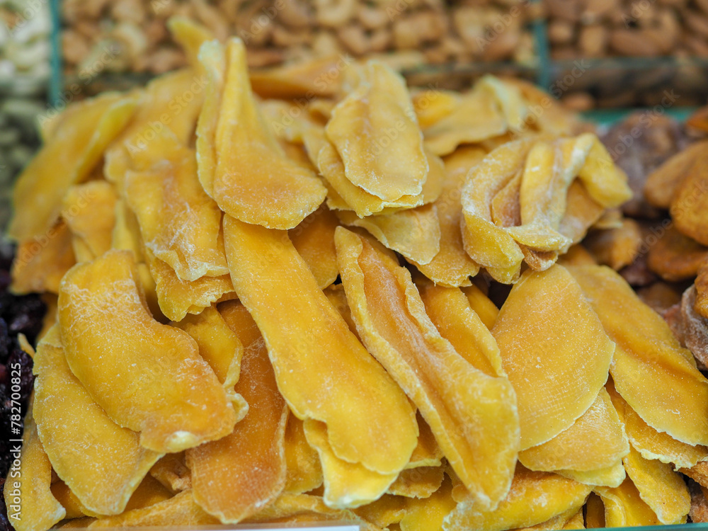 Dried Mango on a Market Counter: Tropical Taste in Every Slice Dried Mango on a Market Counter: Tropical Taste in Every Slice