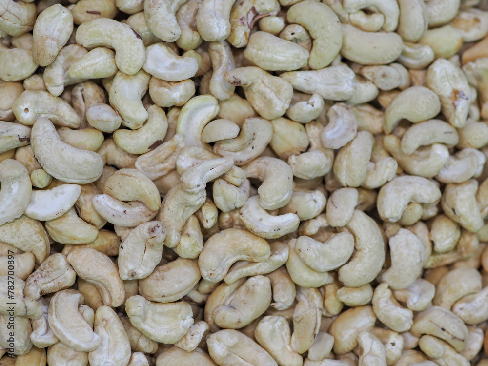 Close-Up: Cashew Nuts on a Light Background, a Symbol of Healthy Eating Close-Up: Cashew Nuts on a Light Background, a Symbol of Healthy Eating