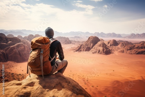 A backpacker taking a moment to admire a vast desert landscape