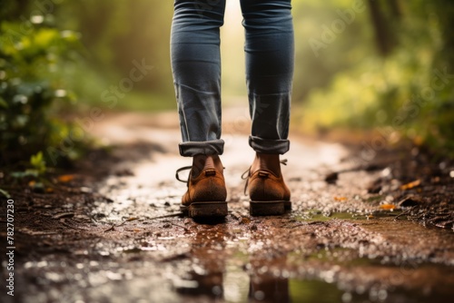 A close up of a person's feet walking on a path