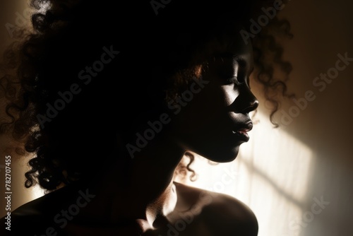 A close-up of a person's silhouette in a contemplative pose