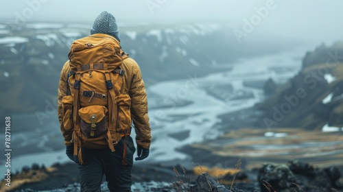An adventurous man trekking explorer in the remote wilderness. Enjoy mountain life In hiking with a backpack back view