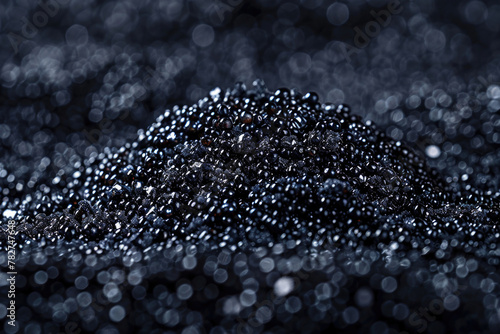 A close-up view of a cluster of black caviar, with its shiny black pearls and delicate membranes