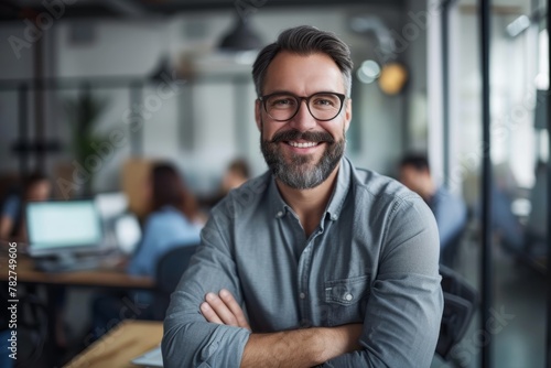 Portrait of smiling businessman boss standing in his modern business company office