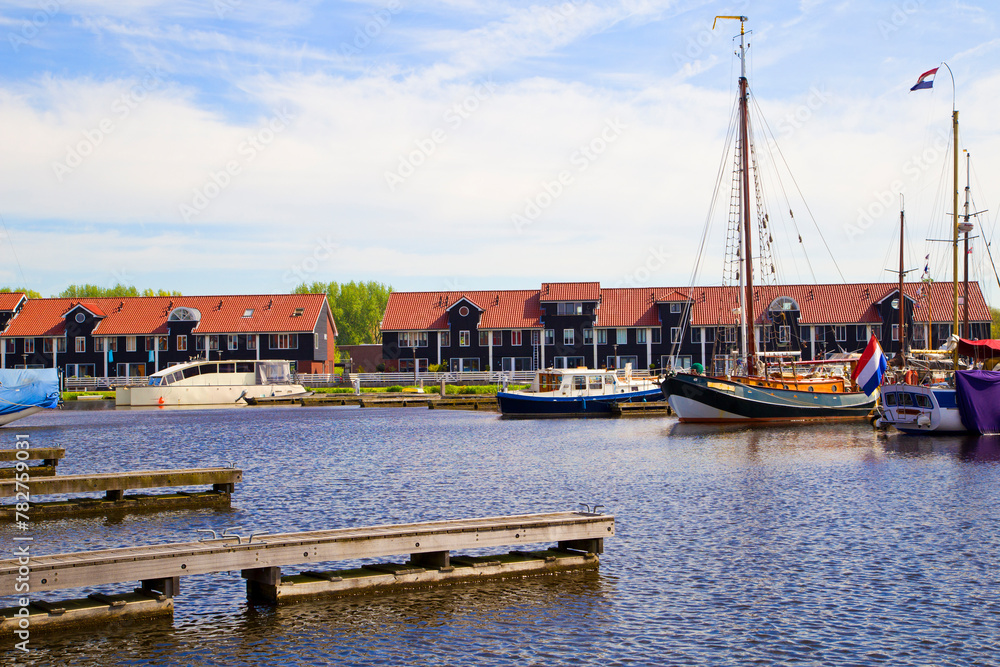 Waterfront with colorful wooden houses in Dutch Reitdiep harbor, Groningen town, Netherlands.