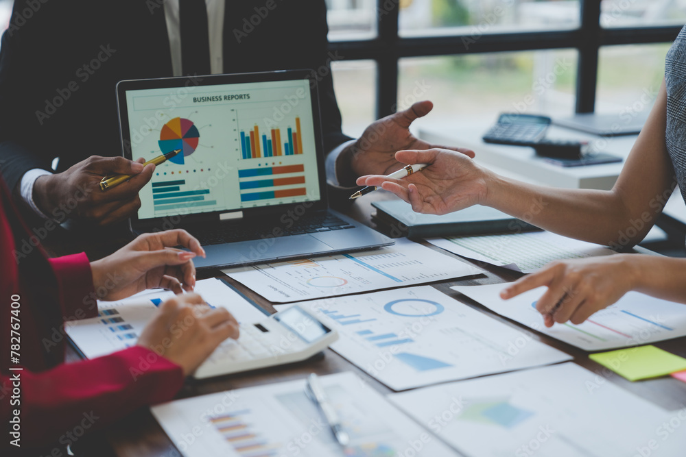 Team work process Business team use calculator to calculate figures, business statistics, profit, cost analysis, growth rate graph document. Data charts on the desk.