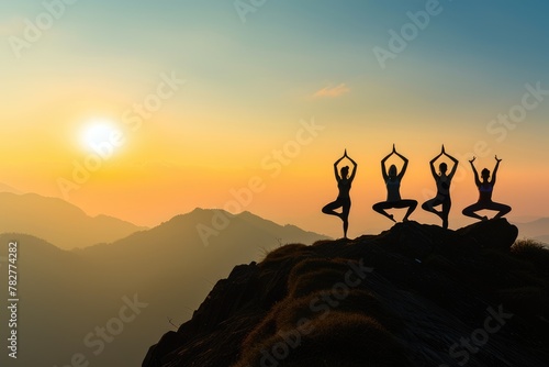 Group of people practicing yoga poses at sunrise on a mountain peak above the clouds  symbolizing peace and mindfulness. Resplendent.