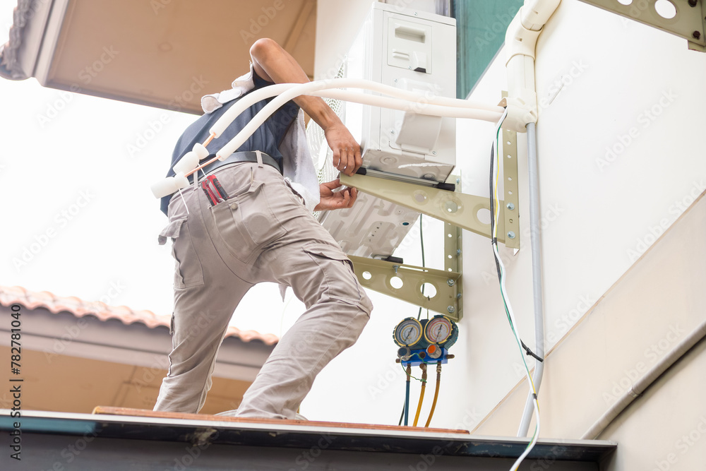 Repairman service for repair and maintenance of air conditioners, Technician man install new air conditioner