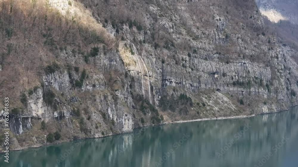The serene beauty of Quinten, Switzerland, from a bird's eye view with this stunning drone footage, sunlight through on mountain and reflects off the tranquil waters of Walensee river. The serene beauty of Quinten, Switzerland, from a bird's eye view with this stunning drone footage, sunlight through on mountain and reflects off the tranquil waters of Walensee river.