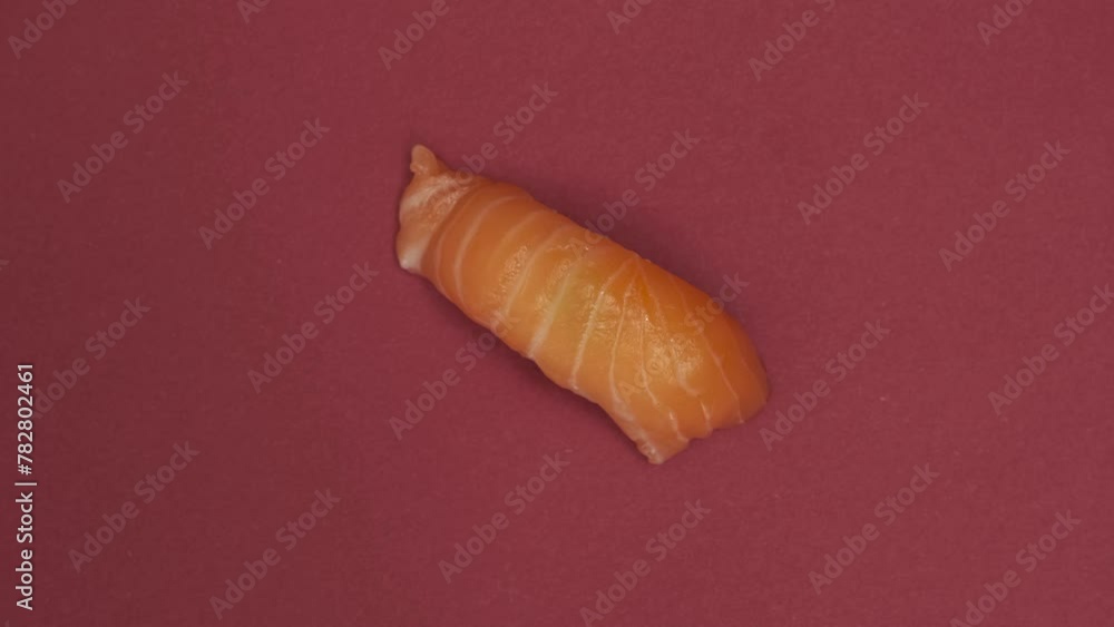 Sushi roll rotating on red background Sushi roll rotating on red background