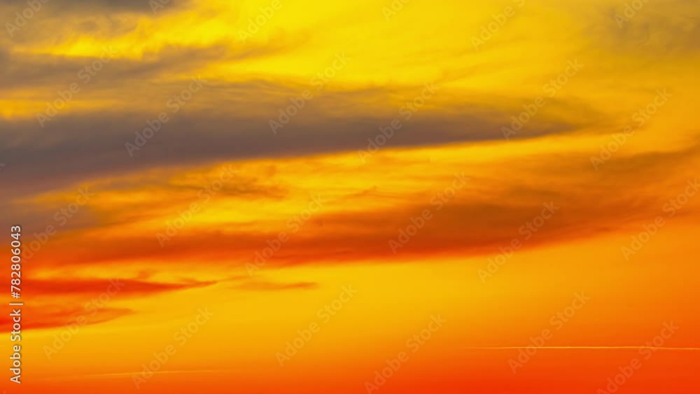 Vibrant fiery sunset or sunrise sky with clouds, time lapse Vibrant fiery sunset or sunrise sky with clouds, time lapse