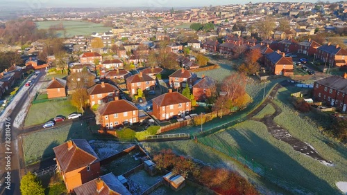 Drone's-eye winter view captures Dewsbury Moore Council estate's typical UK urban council-owned housing development with red-brick terraced homes and the industrial Yorkshire. Working class housing photo