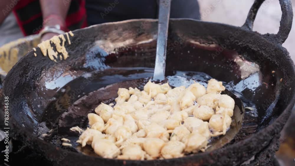 Pakode or pakora or pakhore frying in a Dripping Pan or kadhai by a