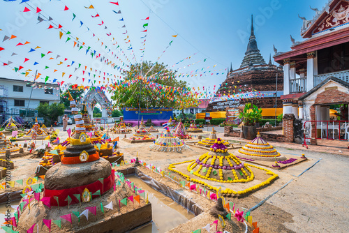 PHITSANULOK, THAILAND - April 9,2024:Thai people come to build the sand Pagoda for return the sand to the temple on Songkran festival Thai tradition at Ratchaburana temple in Phitsanulok,Thailand. photo