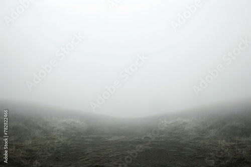 Mysterious foggy landscape with dark ground, grass and sky