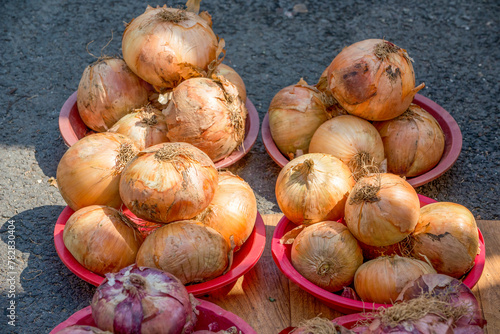Fototapeta Naklejka Na Ścianę i Meble -  Close up of baskets full of onions sold at the market