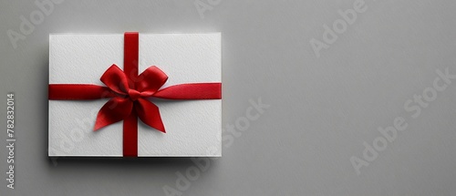 Sleek white gift card  tied red ribbon  grey background  subtle shadow  minimalist  text space