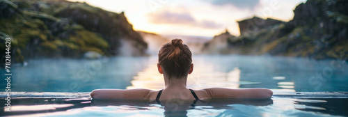 Young woman enjoying spa in hot springs in iceland