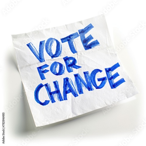 Election Day Concept - Vote Change blue text written on white note paper, possibly a political sign, advocating voting and supporting change.