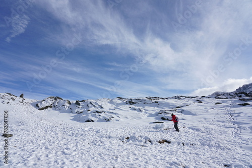 View of snow on the mountain top and beautiful sky with white clouds. Along with pictures of unknown hikers who came to see the beautiful scenery in Switzerland.