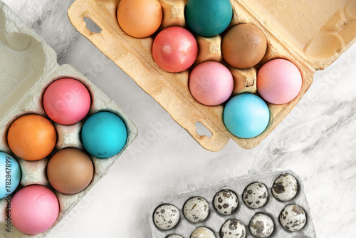 Multi-colored Easter chicken eggs lie on table. close-up, flat lay. top view, 90 degrees. minimalism, Easter decor, Easter card, postcard. Concept of preparation for holiday, Easter holiday © Маргарита Трушина