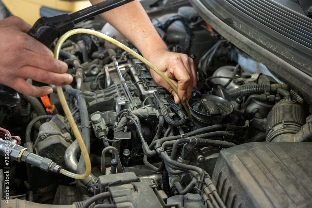 close-up photo of a mechanic's hands repairing a car diesel engine close-up photo of a mechanic's hands repairing a car diesel engine