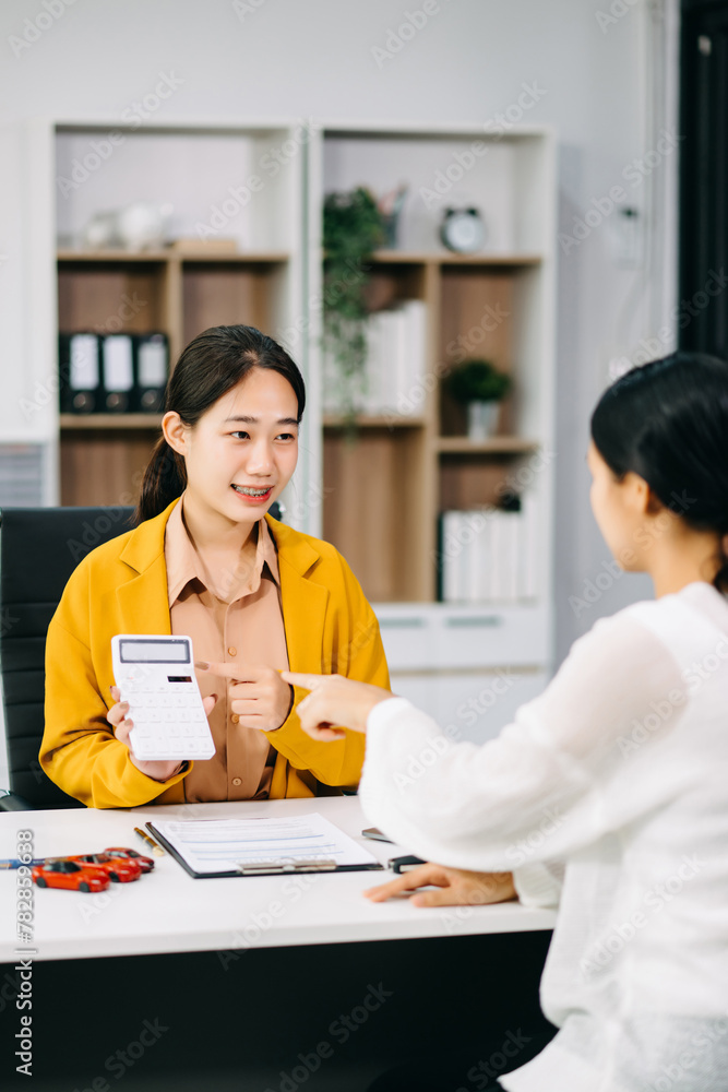 Asian people car salesman or sales manager offers to sell a car and explains of signing a car contract and signing car insurance document . Asian people car salesman or sales manager offers to sell a car and explains of signing a car contract and signing car insurance document .