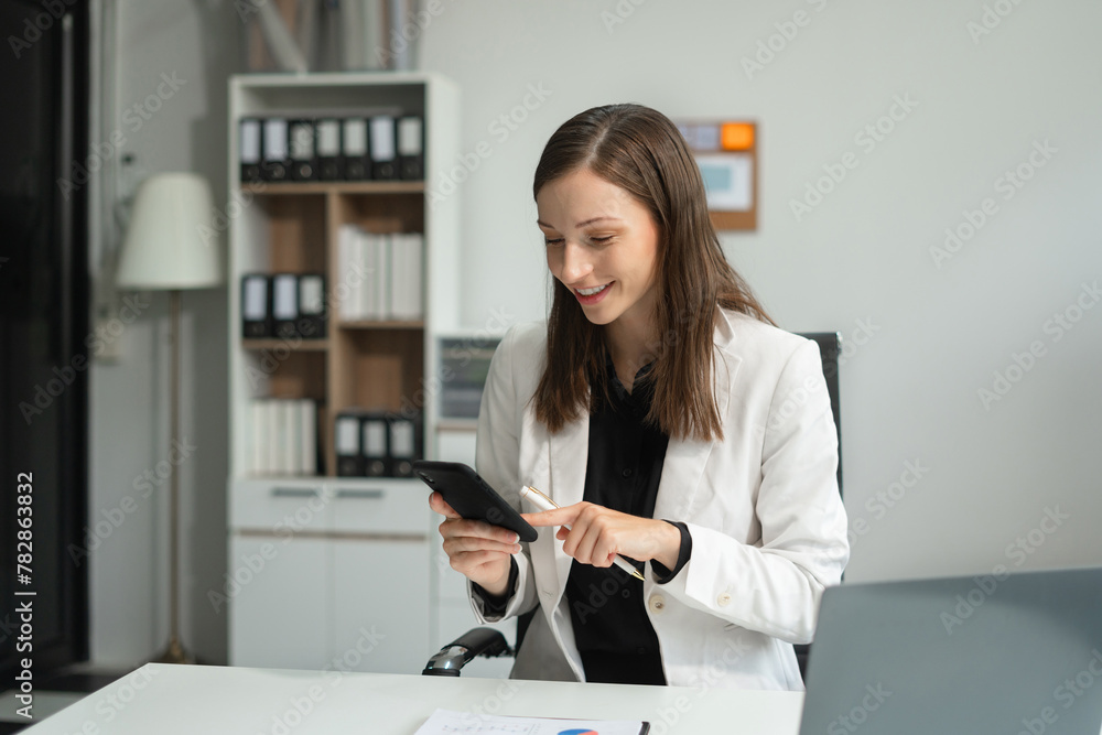 Businesswoman talk mobile phones and working on laptop computers, online business. Businesswoman talk mobile phones and working on laptop computers, online business.