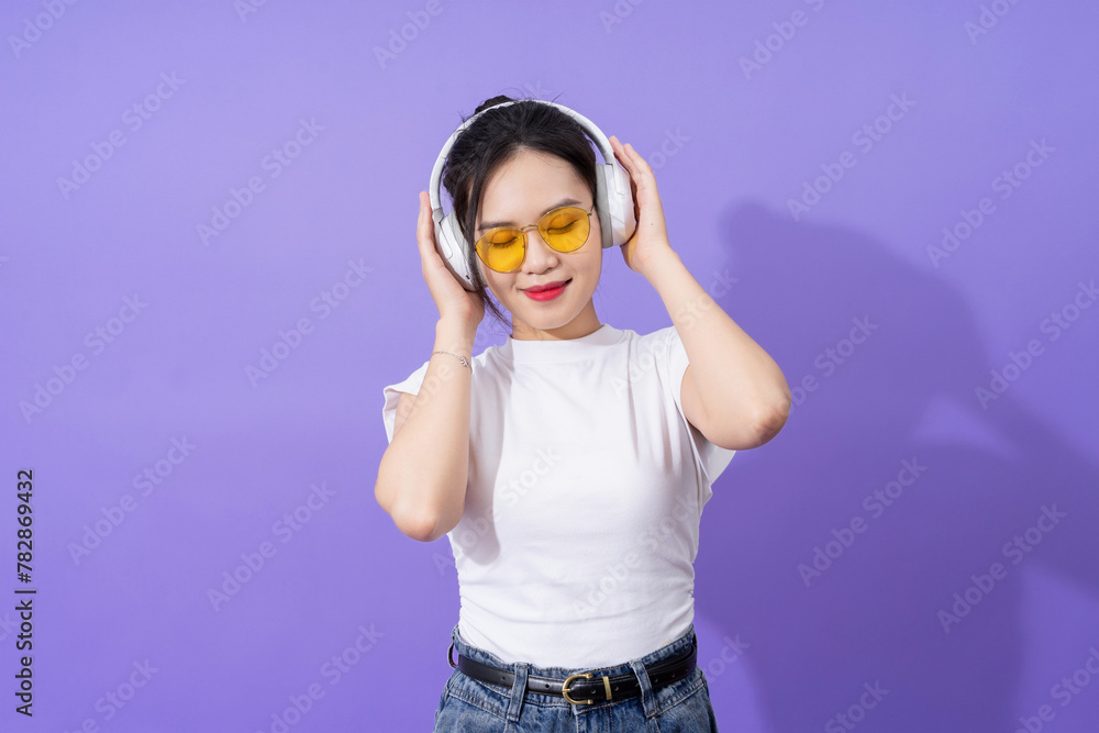 Young Asian teenager on purple background Young Asian teenager on purple background