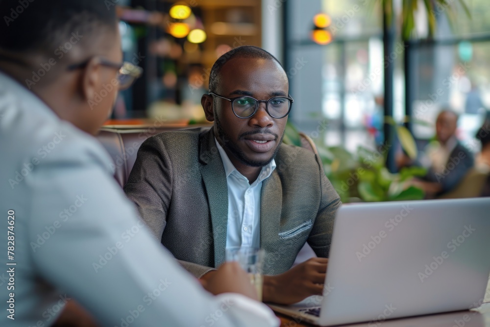 Fototapeta premium Two businessmen having a discussion at a cafe or restaurant Fictional Character Created by Generative AI.