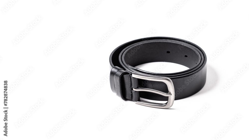 Twisted black leather belt with matted metal buckle isolated on white background. Fastened fashionable unisex, man or woman accessory for trousers, jeans, dress. Male luxury strap. Haberdashery goods Twisted black leather belt with matted metal buckle isolated on white background. Fastened fashionable unisex, man or woman accessory for trousers, jeans, dress. Male luxury strap. Haberdashery goods
