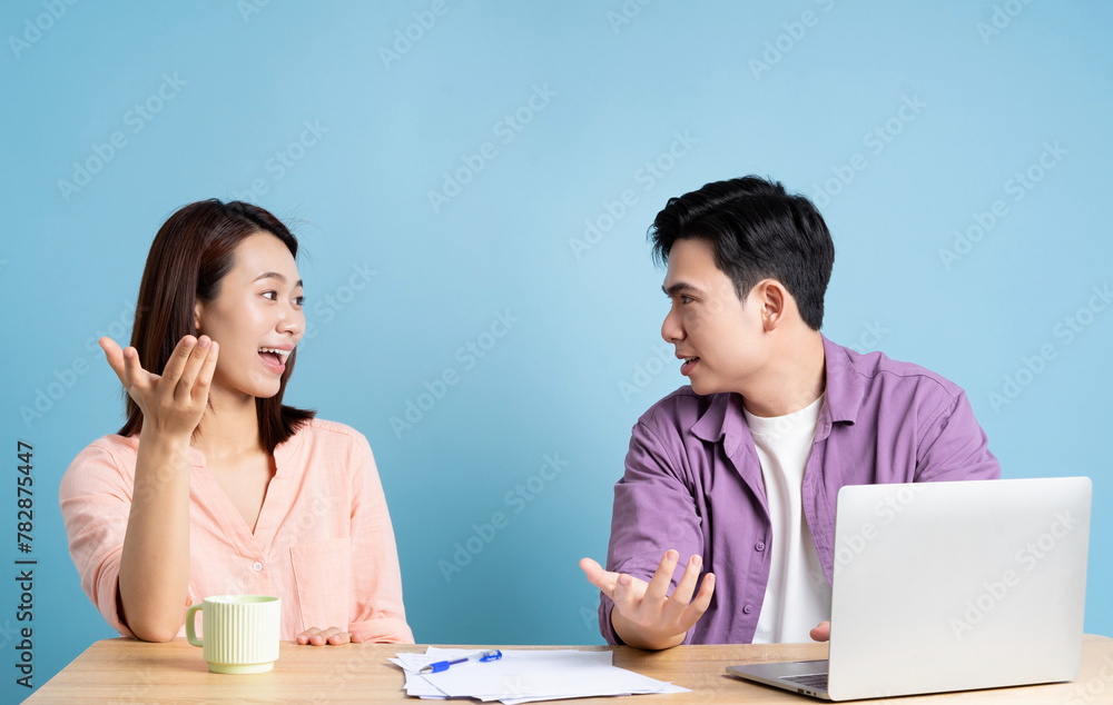 Photo of two Asian businessperson on blue background Photo of two Asian businessperson on blue background