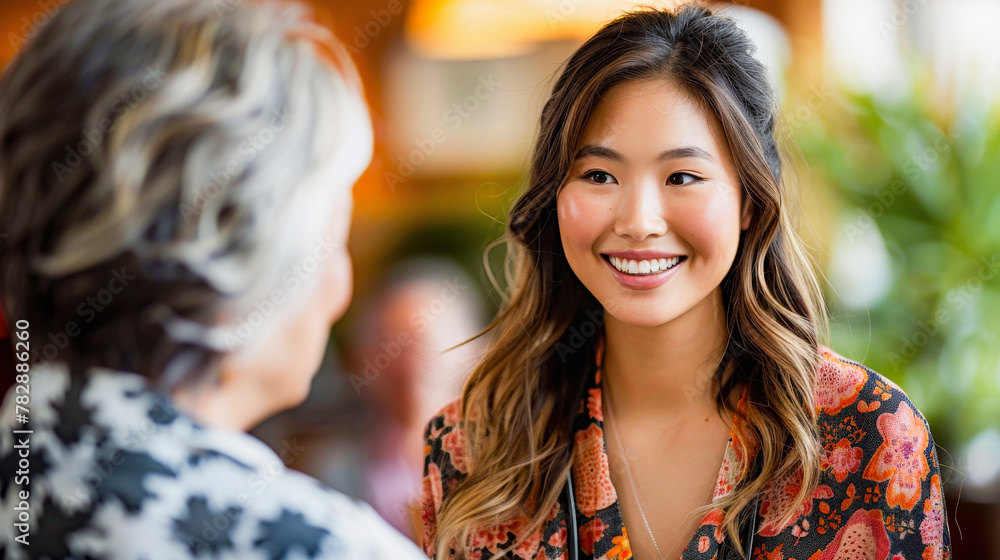 Young woman with a joyful smile having a conversation with an older adult in a cozy indoor setting. Young woman with a joyful smile having a conversation with an older adult in a cozy indoor setting.