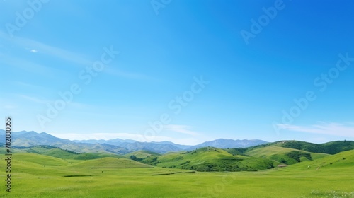  Bright, cloudless blue sky on a green mountain background. 