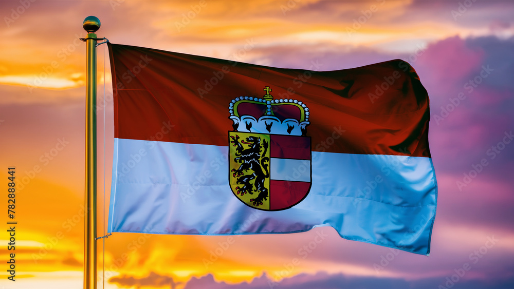 Fototapeta premium Salzburg Waving Flag Against a Cloudy Sky at Sunset.