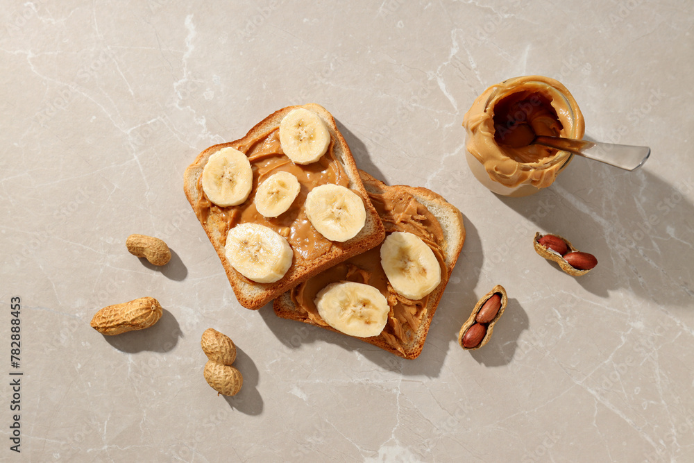 Peanut paste in a glass jar with toast, on a light background. Peanut paste in a glass jar with toast, on a light background.