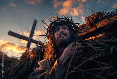 Light and clouds on a sunset hill and Jesus carrying the cross of suffering symbolizing death, sacrifice and resurrection photo