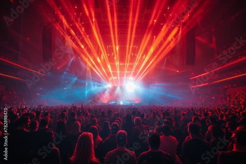 Vibrant atmosphere as an ecstatic crowd enjoys a concert illuminated by a dazzling light show and stage effects