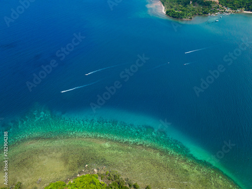 Aerial view of turquoise lagoon surface on atoll and coral reef  copy space for text. Top view transparent turquoise ocean water surface.