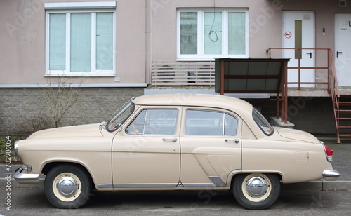 A bright Soviet car is parked under the windows of an apartment building, Soyuzny Prospekt, St. Petersburg, Russia, April 12, 2024
