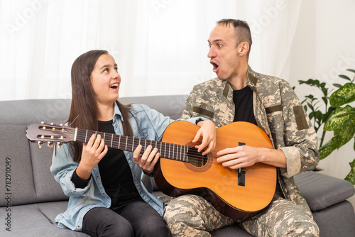 a veteran and his daughter play the guitar