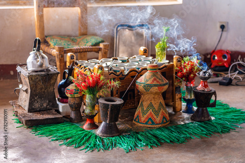 Ethiopian traditional coffee served with aromatic essence. Ceremony with Incense, frankincense and myrrh ignited by hot coal produce smoke that carries away bad any spirits. Debre Libanos, Ethiopia photo