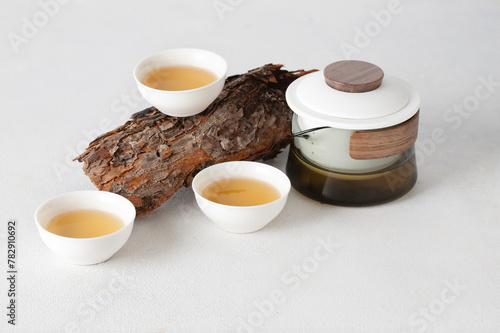 Oriental Tea set of teapot and cups on wooden podium at white background, minimalist menu for teahouse