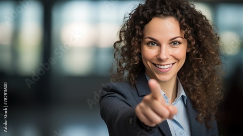 Portrait of smiling business woman pointing finger 